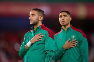 Chelsea star, Hakim Ziyech, with Morocco teammate Achraf Hakimi, stands for the national anthem.