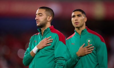 Chelsea star, Hakim Ziyech, with Morocco teammate Achraf Hakimi, stands for the national anthem.