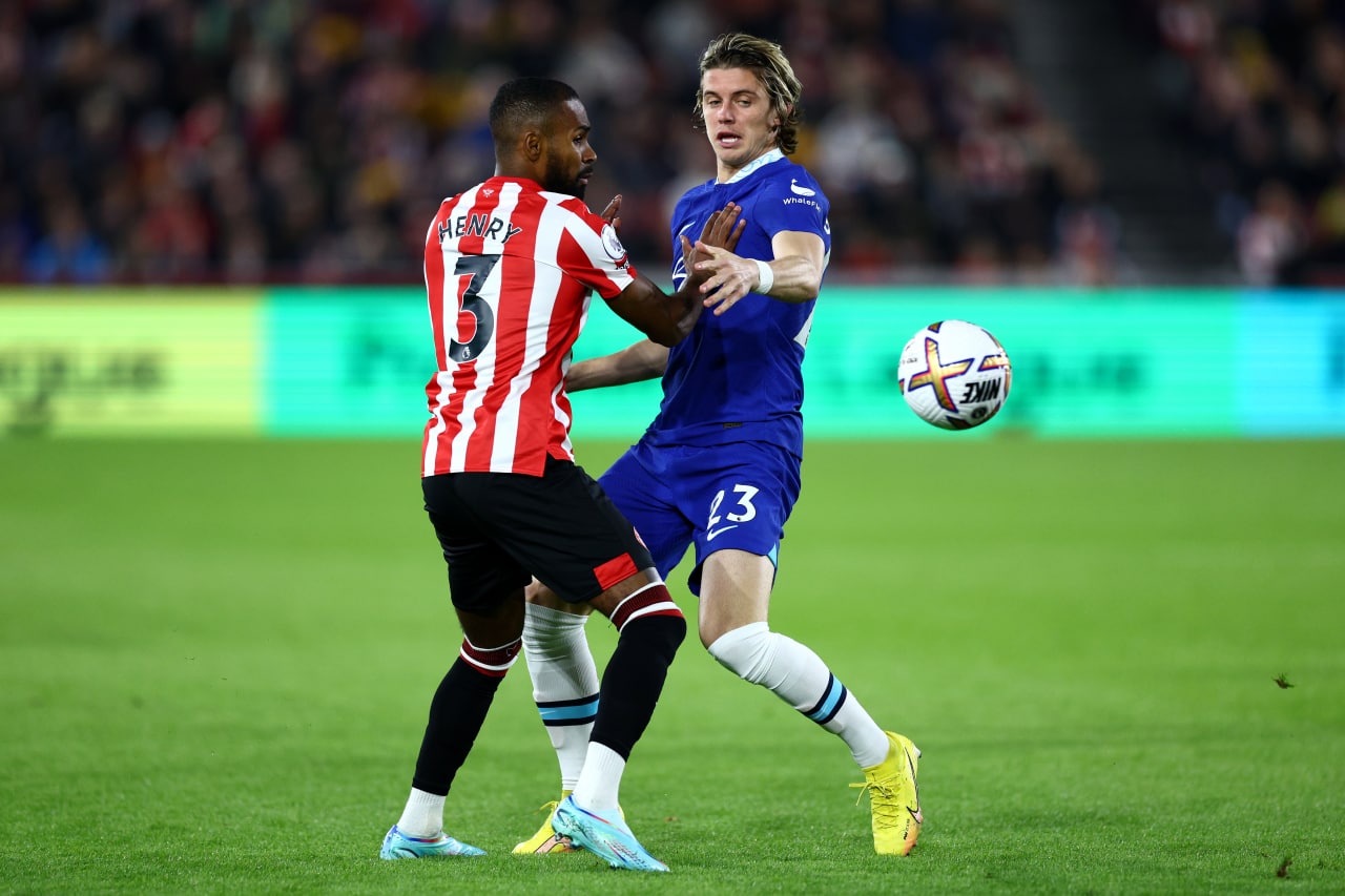 Conor Gallagher of Chelsea battles for possession with Rico Henry of Brentford.