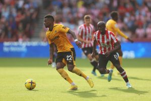 Nelson Semedo of Wolverhampton Wanderers is marked by Yoane Wissa of Brentford during the Premier League match between Brentford FC and Wolverhampton Wanderers at Brentford Community Stadium on October 29, 2022 in Brentford, England.
