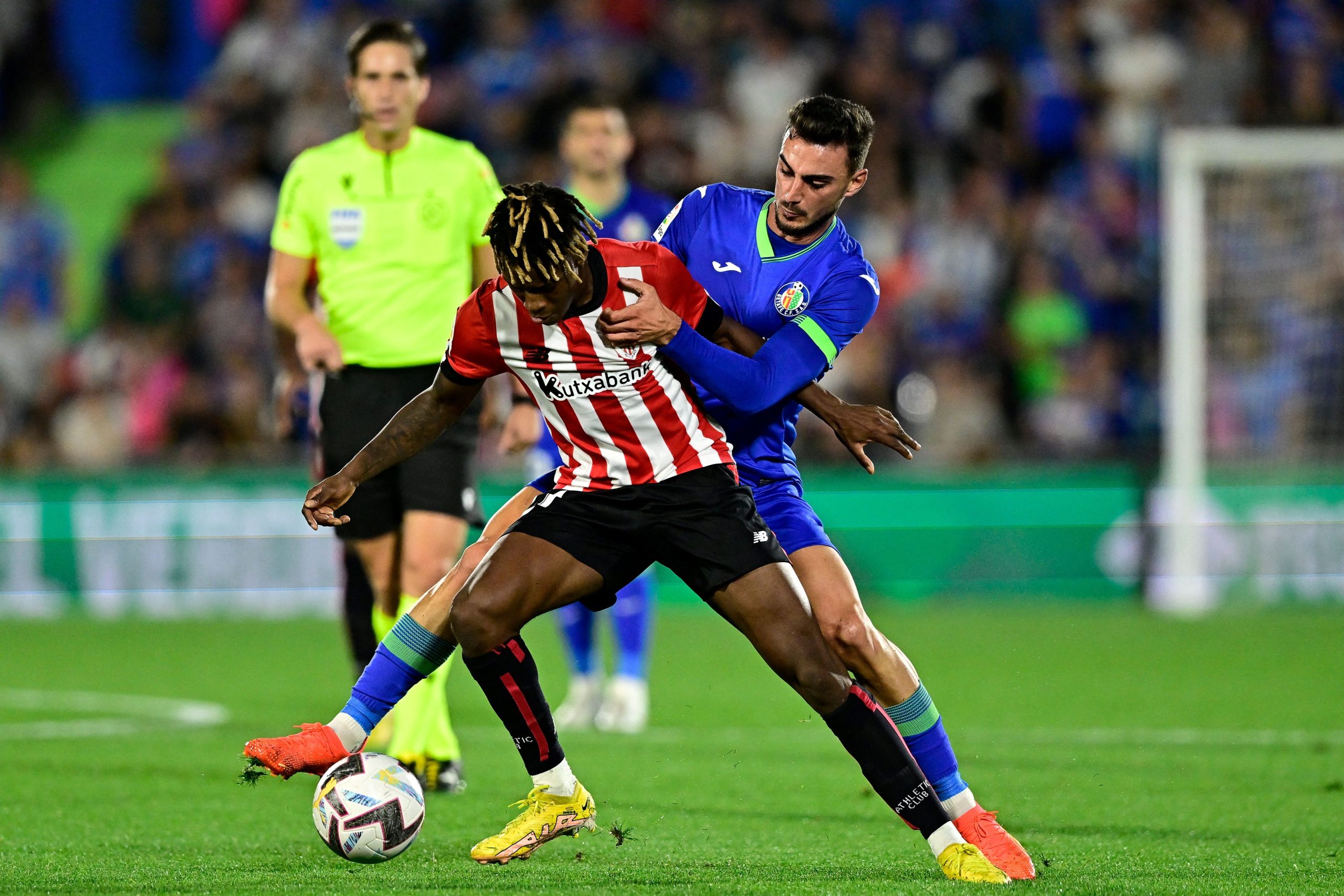 Athletic Bilbao's Spanish forward Nico Williams fights for the ball with Getafe's Juan Iglesias. (Photo by JAVIER SORIANO/AFP via Getty Images)