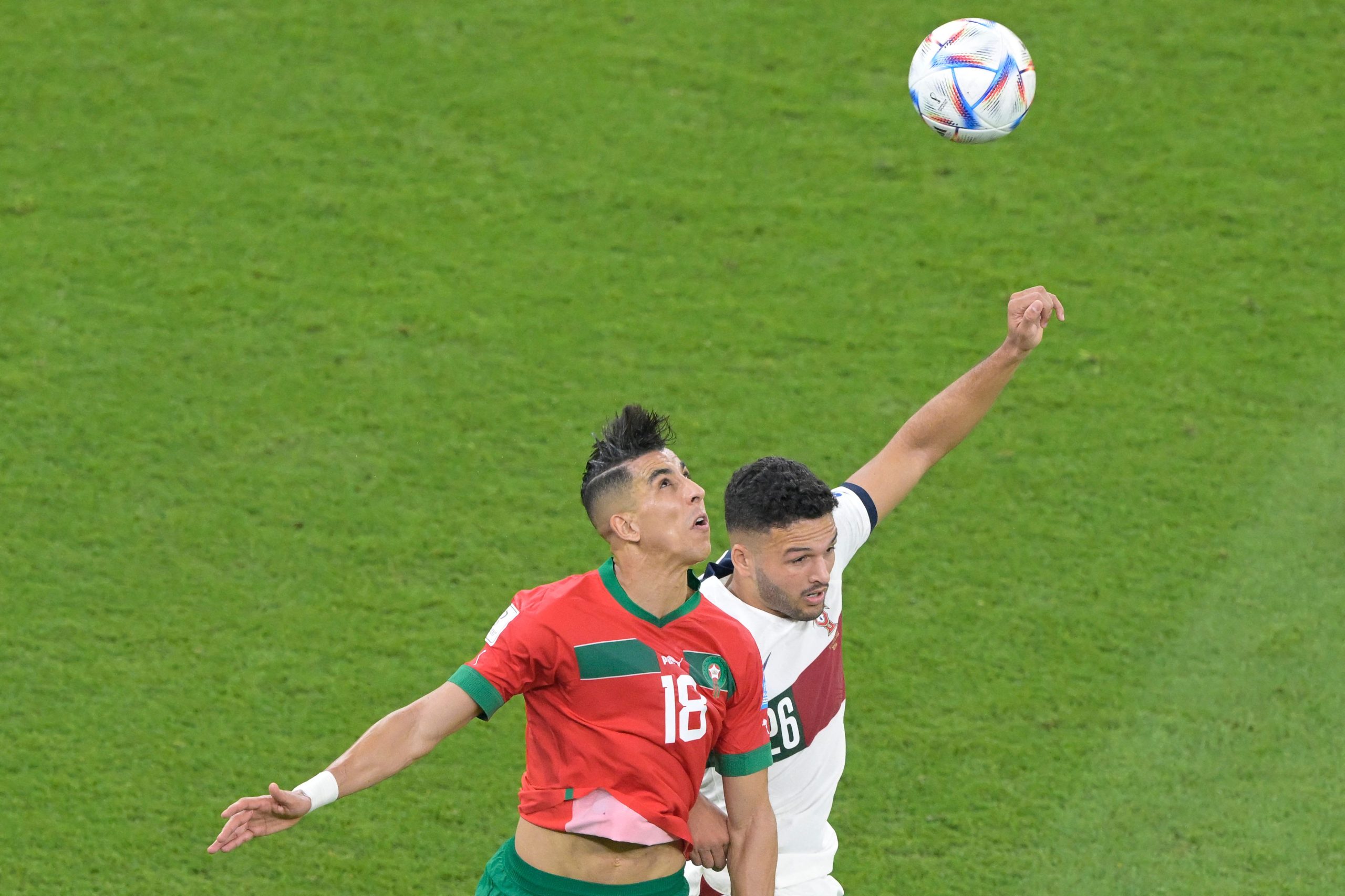 Morocco's Jawad El Yamiq and Portugal's Goncalo Ramos jump for a header.