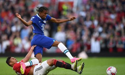 Manchester United's Brazilian midfielder Casemiro slides in to tackle Chelsea's English midfielder Carney Chukwuemeka.