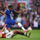 Manchester United's Brazilian midfielder Casemiro slides in to tackle Chelsea's English midfielder Carney Chukwuemeka.