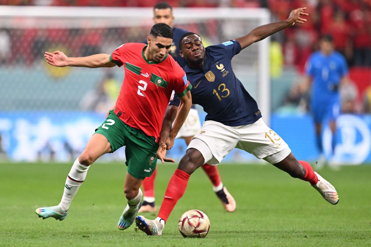 France's midfielder Youssouf Fofana fights for the ball with Morocco's Achraf Hakimi. (Photo by KIRILL KUDRYAVTSEV/AFP via Getty Images)