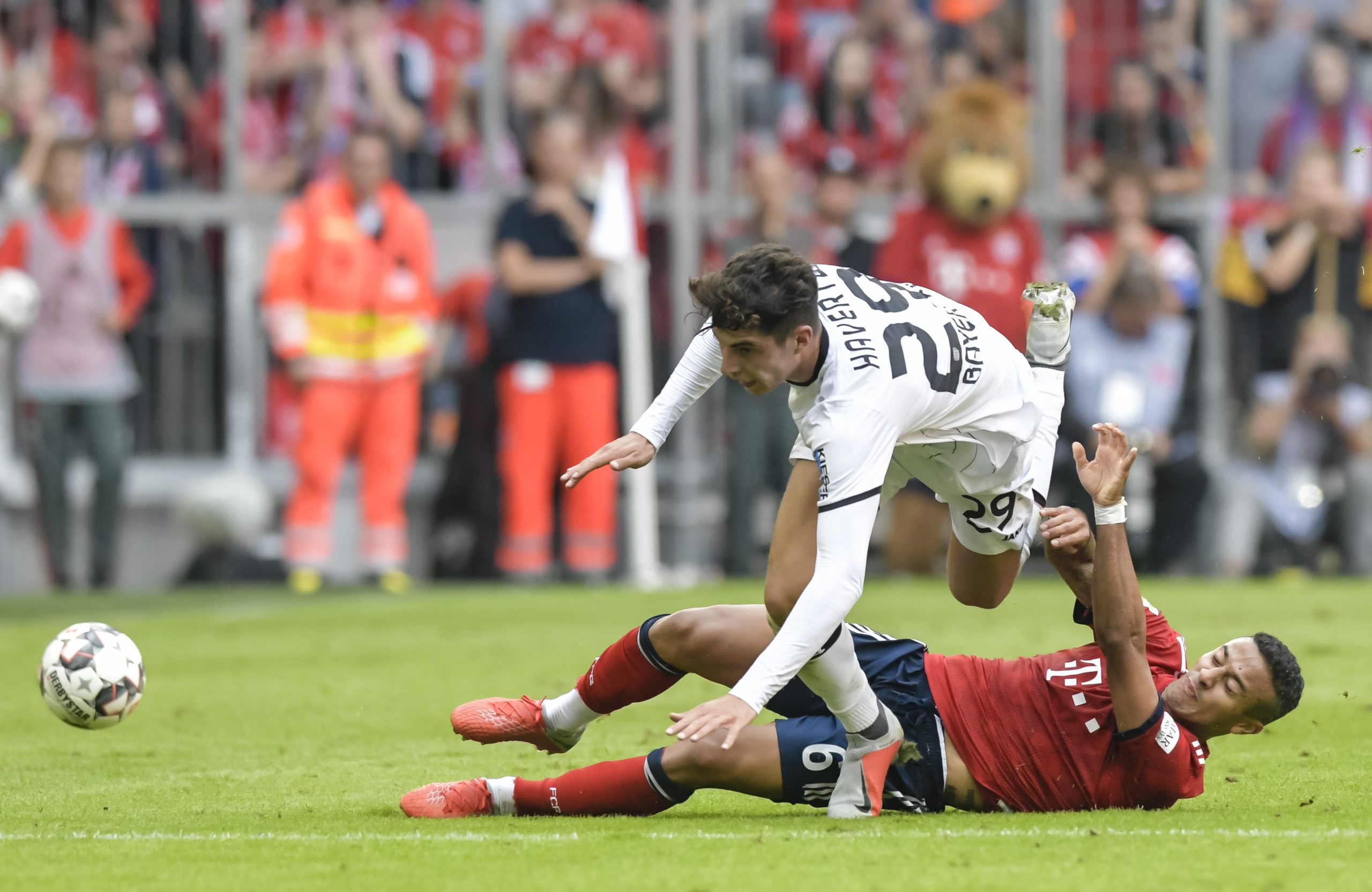 Bayern Munich's Thigao Alcantara and Leverkusen's Kai Havertz vie for the ball.