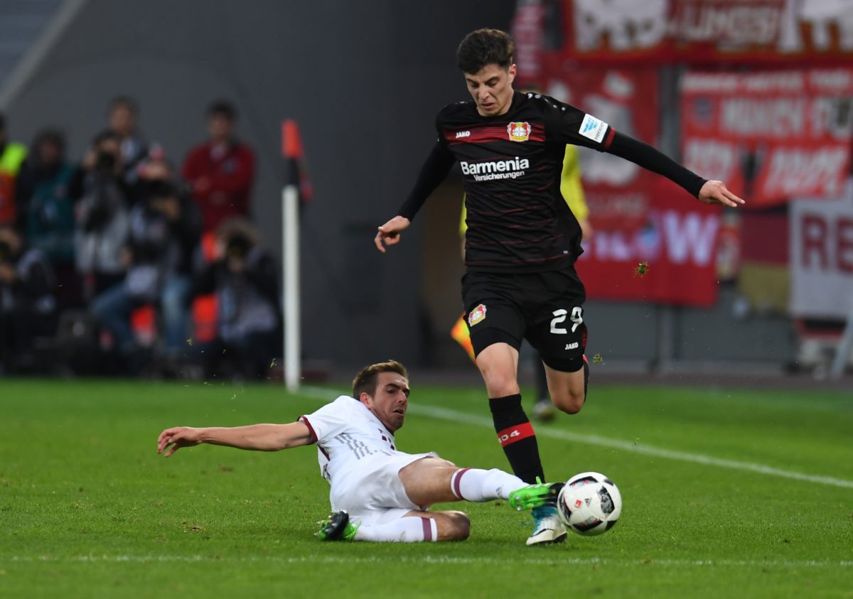 Bayern Munich's Philipp Lahm and Leverkusen's Kai Havertz vie for the ball. 
