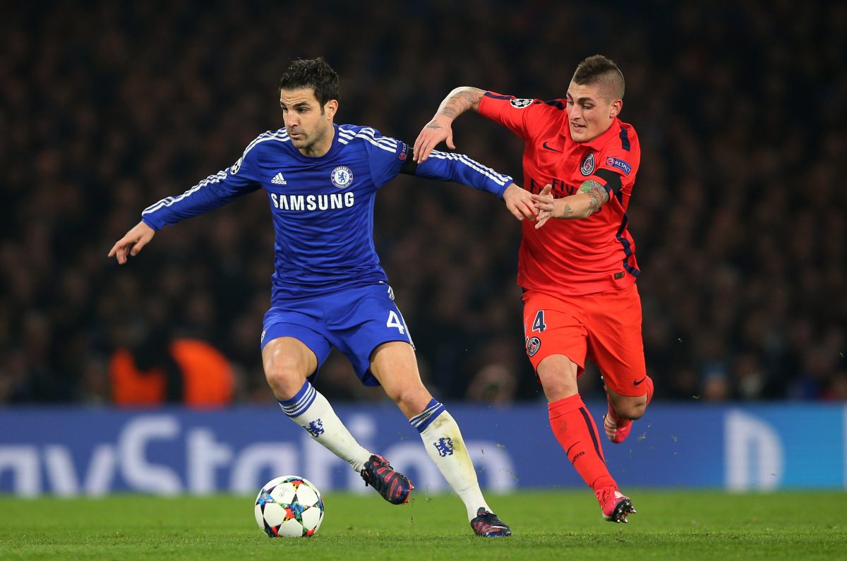 Cesc Fabregas of Chelsea hjolds off the challenge from Marco Verratti of PSG.  (Photo by Paul Gilham/Getty Images)