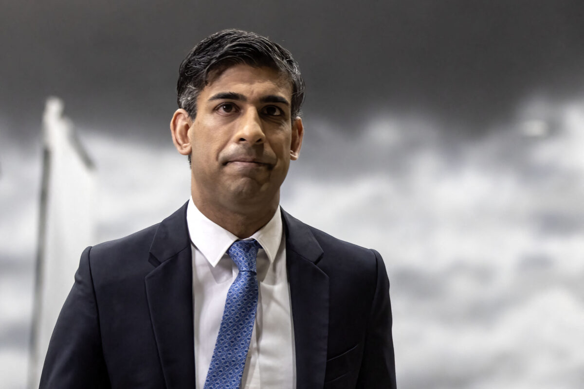 Britain's Prime Minister Rishi Sunak reacts after giving an interview to a TV journalist, standing in front of a back drop of a stormy sky, painted by students in a film studio, during his visit to the National Film and Television School in Beaconsfield on January 22, 2024. (Photo by Richard Pohle / POOL / AFP) (Photo by RICHARD POHLE/POOL/AFP via Getty Images)